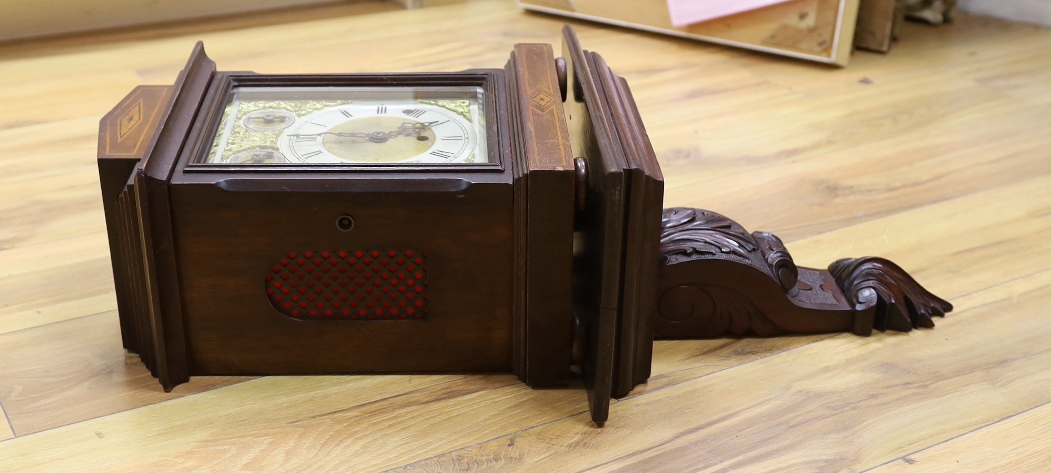 A Edwardian inlaid mahogany bracket clock, with traditional dial and chiming mechanism, clock 37cms high, bracket 33cms high